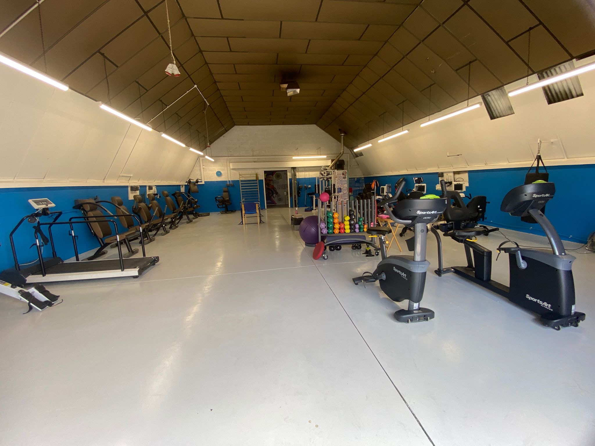 The Angel Centre therapy gym showing specialized accessible exercise equipment and supportive environment for people with disabilities and chronic health conditions